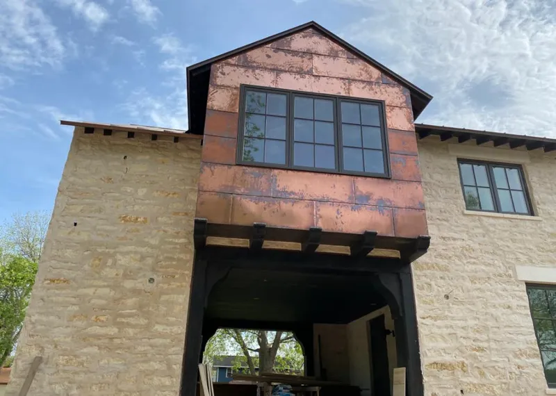 Copper metal panel facade on a stone building for Skylight Installation in The Village of Indian Hill