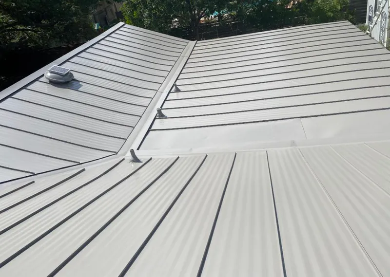 Solar attic fan installed on a metal roof for Roof Ventilation in The Village of Indian Hill